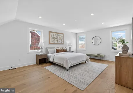a bedroom with a large bed and a couch