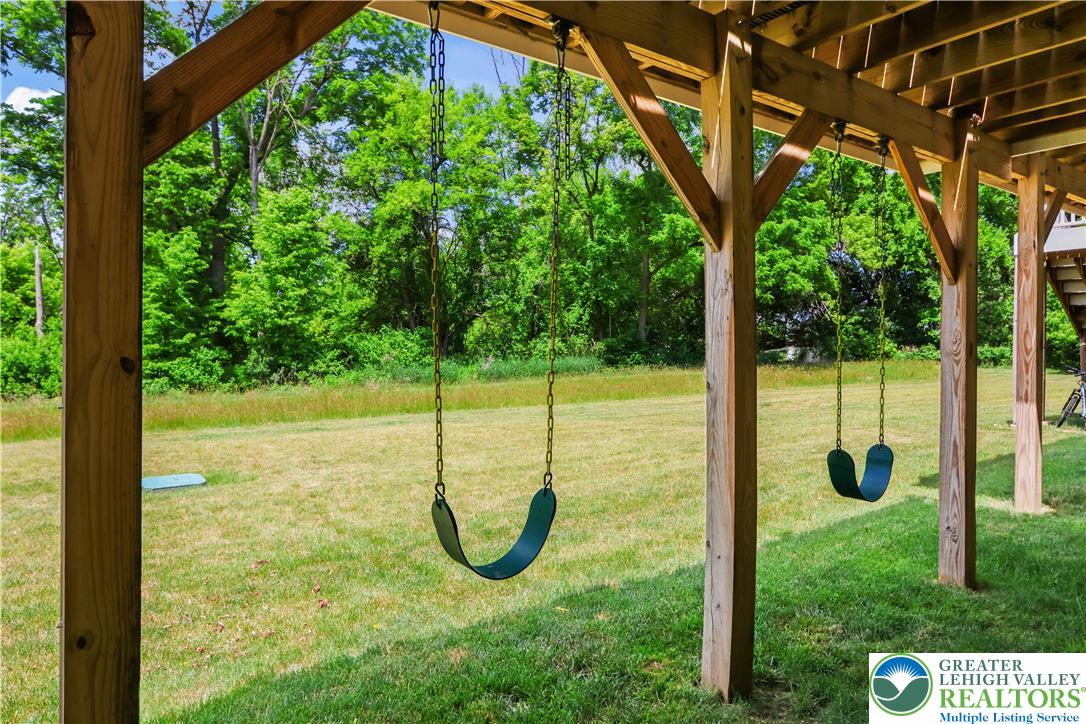 2336 Alex Road Easton, PA 18040 - Photo 26 of 35 A tranquil backyard setting provides ample space for recreation and relaxation, complete with swings for playful afternoons.