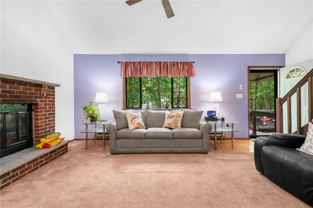 222 Powder Horn Road Henryville, PA 18332 - Photo 5 of 25 A welcoming living room featuring a brick fireplace and abundant natural light.