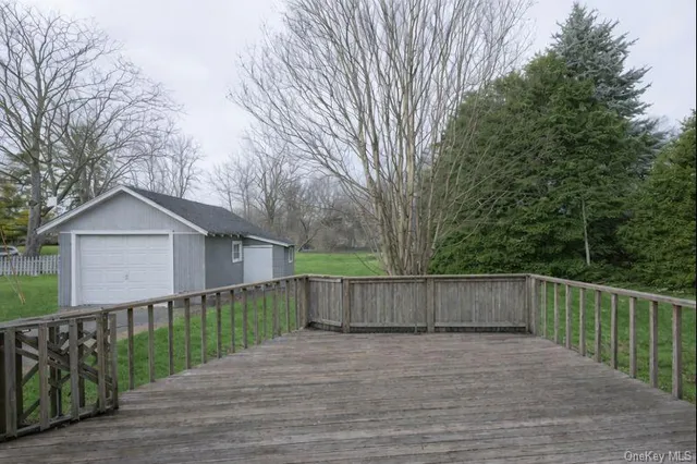 a view of a wooden fence and a trees