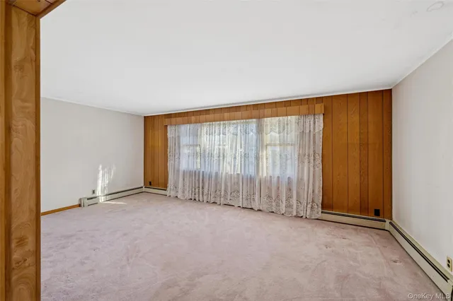 an empty room with large windows