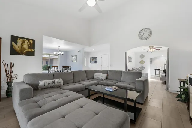 a living room with furniture and a floor to ceiling window