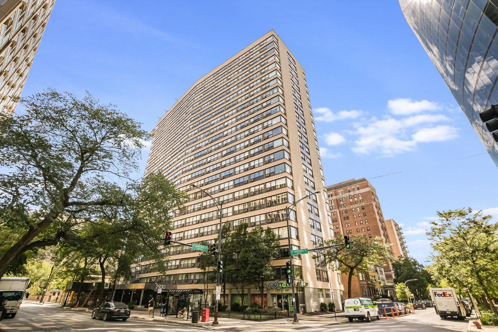 2930 North Sheridan Road, Unit 1111 Chicago, IL 60657 - Photo 1 of 28 a front view of a building with lot of cars and trees