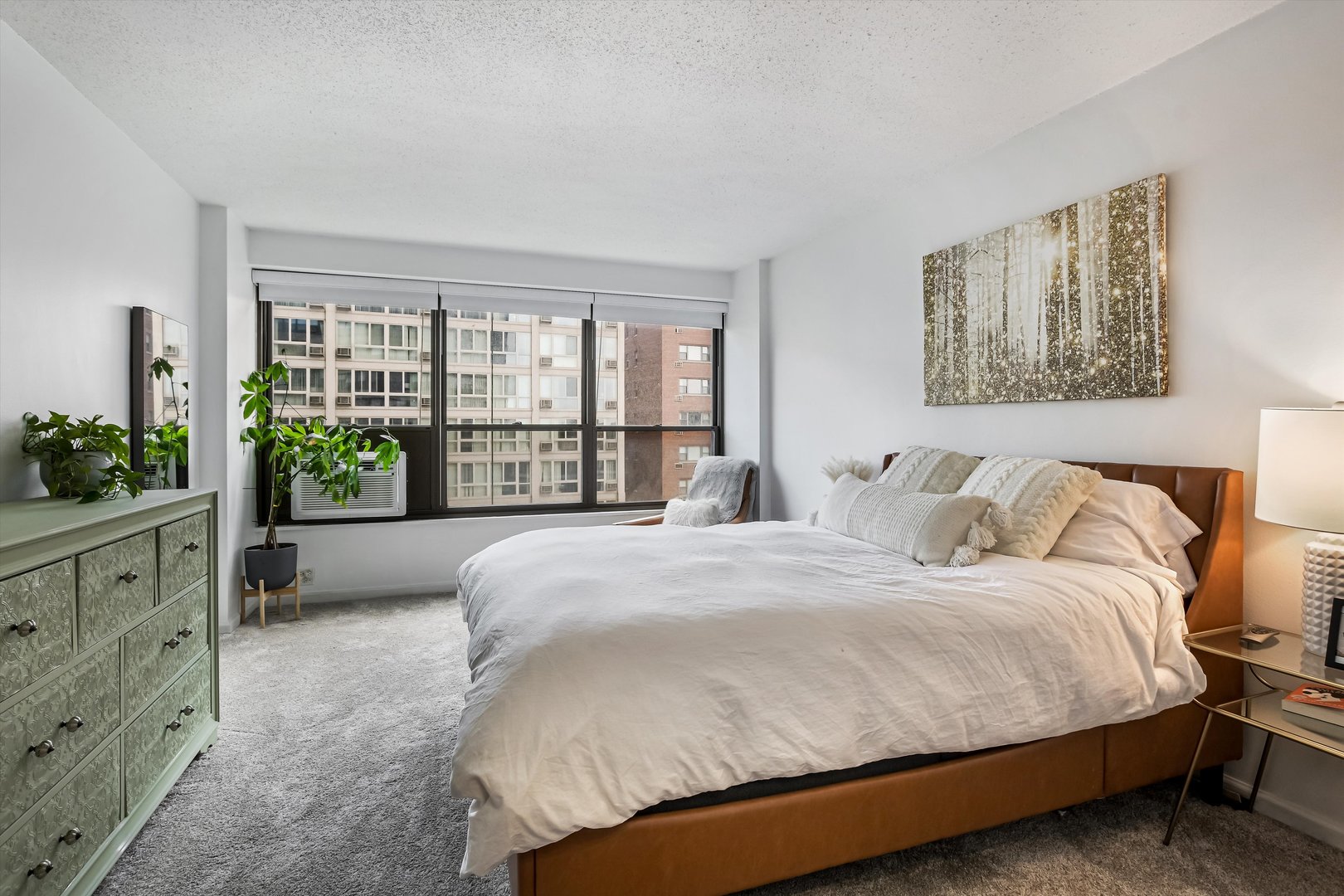 2930 North Sheridan Road, Unit 1111 Chicago, IL 60657 - Photo 11 of 28 a spacious bedroom with a bed and a large window