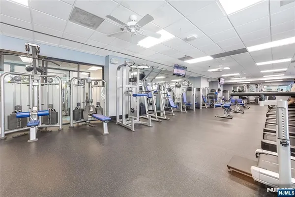 a room with gym equipment and floor to ceiling window