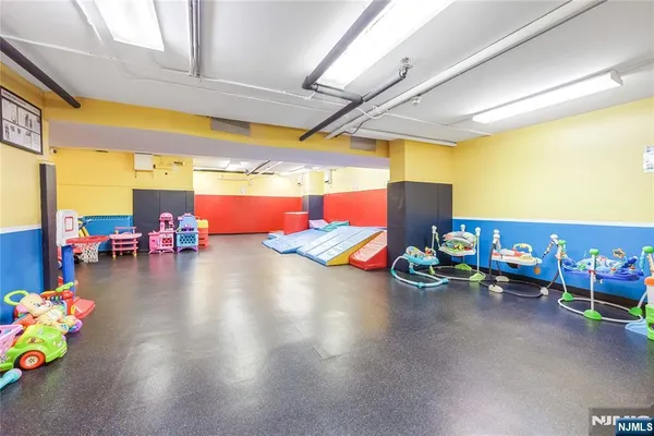 a view of a room that has a bed and a mirror in it