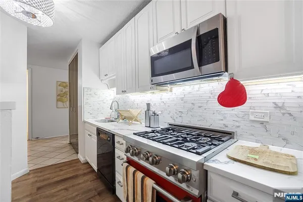 a kitchen with a sink stove and refrigerator