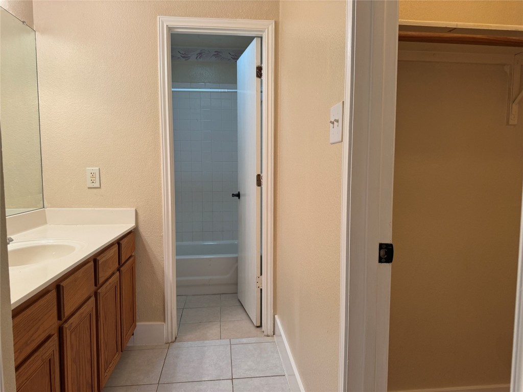 12309 Turtle Rock Road, Unit A Austin, TX 78729 - Photo 11 of 14 a bathroom with a sink and a mirror