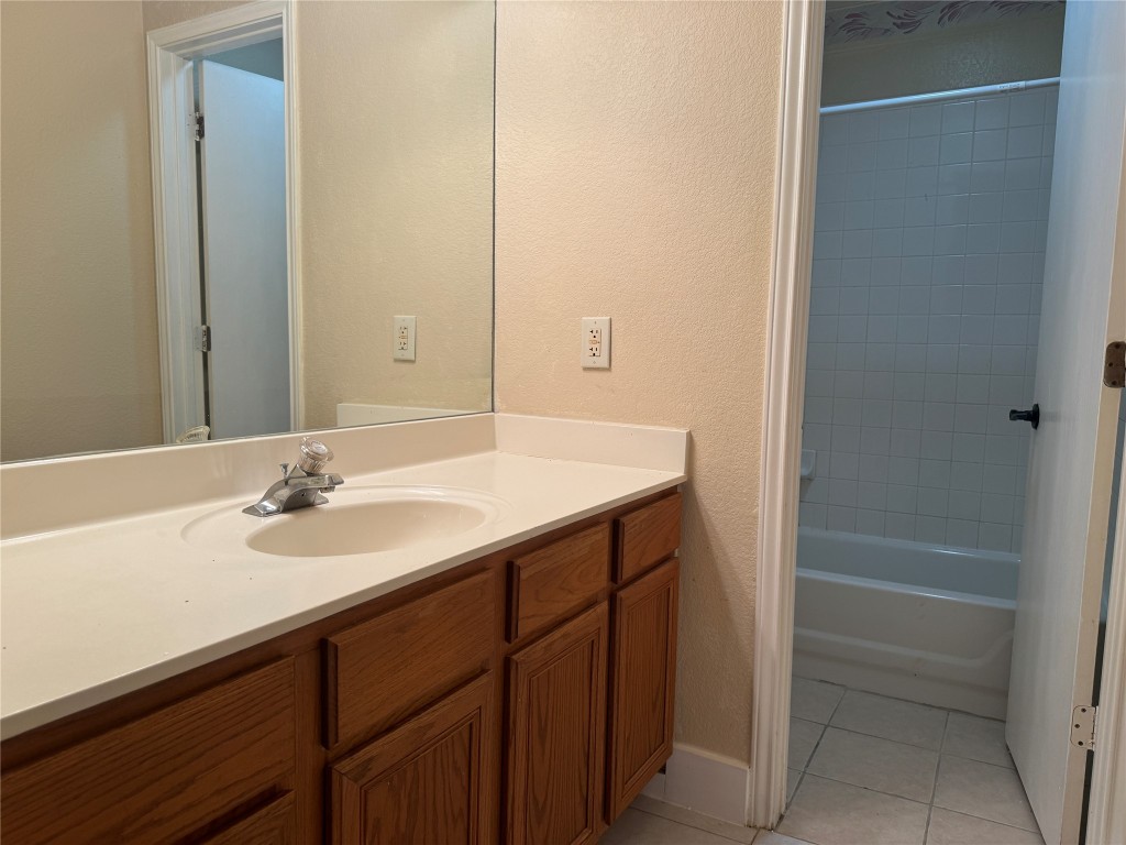12309 Turtle Rock Road, Unit A Austin, TX 78729 - Photo 12 of 14 a bathroom with a sink and a mirror