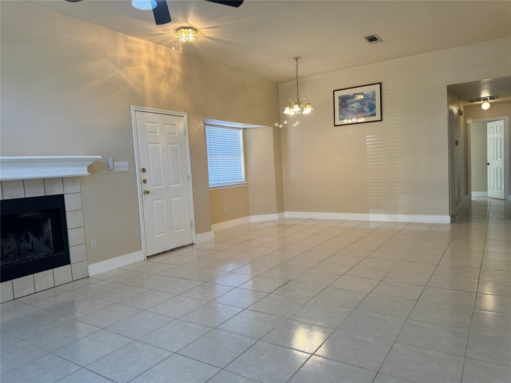 12309 Turtle Rock Road, Unit A Austin, TX 78729 - Photo 3 of 14 an empty room with windows and fireplace