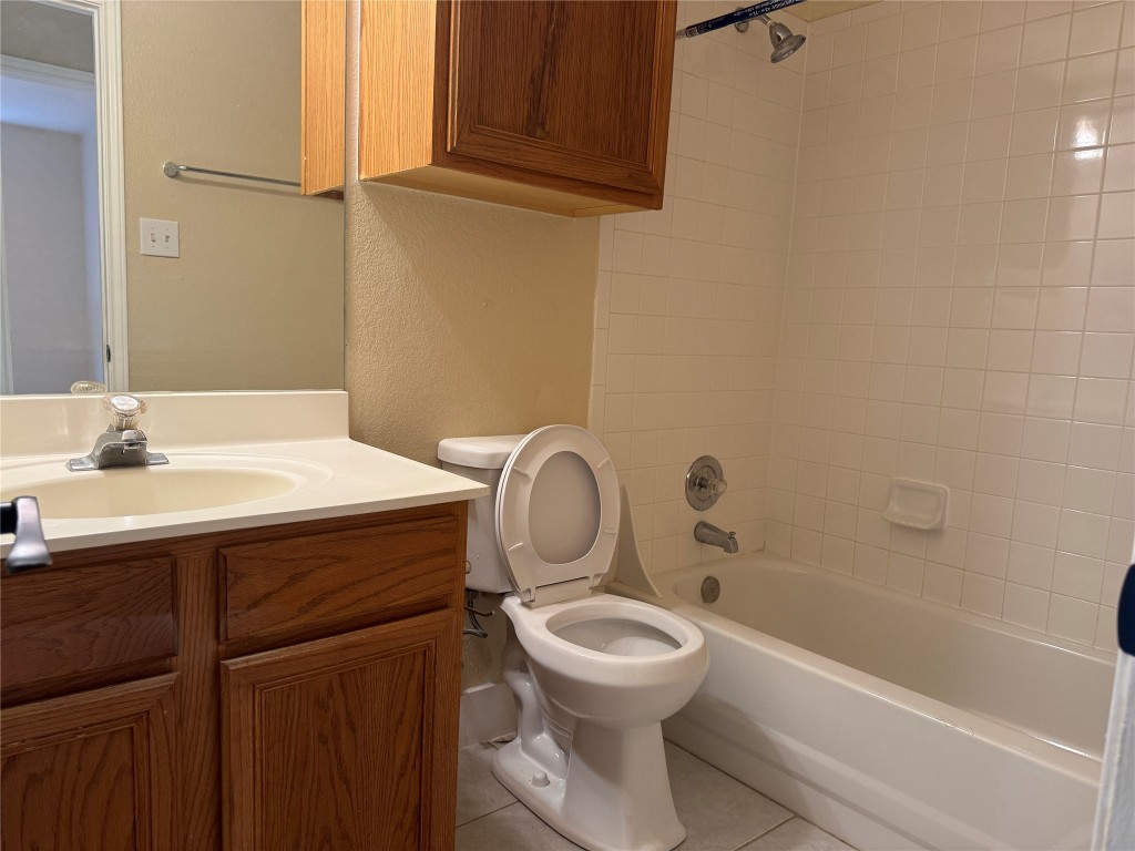 12309 Turtle Rock Road, Unit A Austin, TX 78729 - Photo 8 of 14 a bathroom with a sink a toilet and bathtub