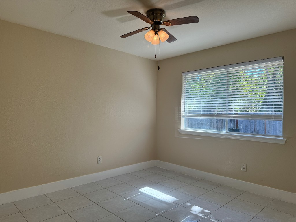 12309 Turtle Rock Road, Unit A Austin, TX 78729 - Photo 10 of 14 an empty room with a window