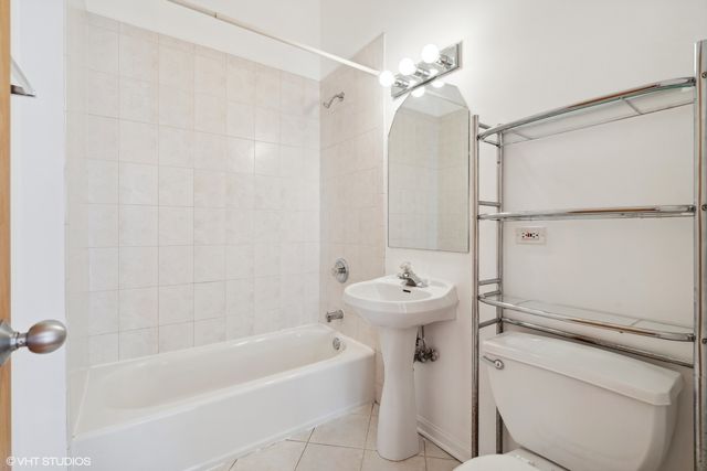 a bathroom with a sink a toilet a mirror and shower