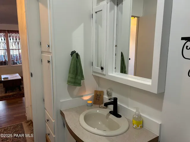 a room with a flat screen tv and a potted plant