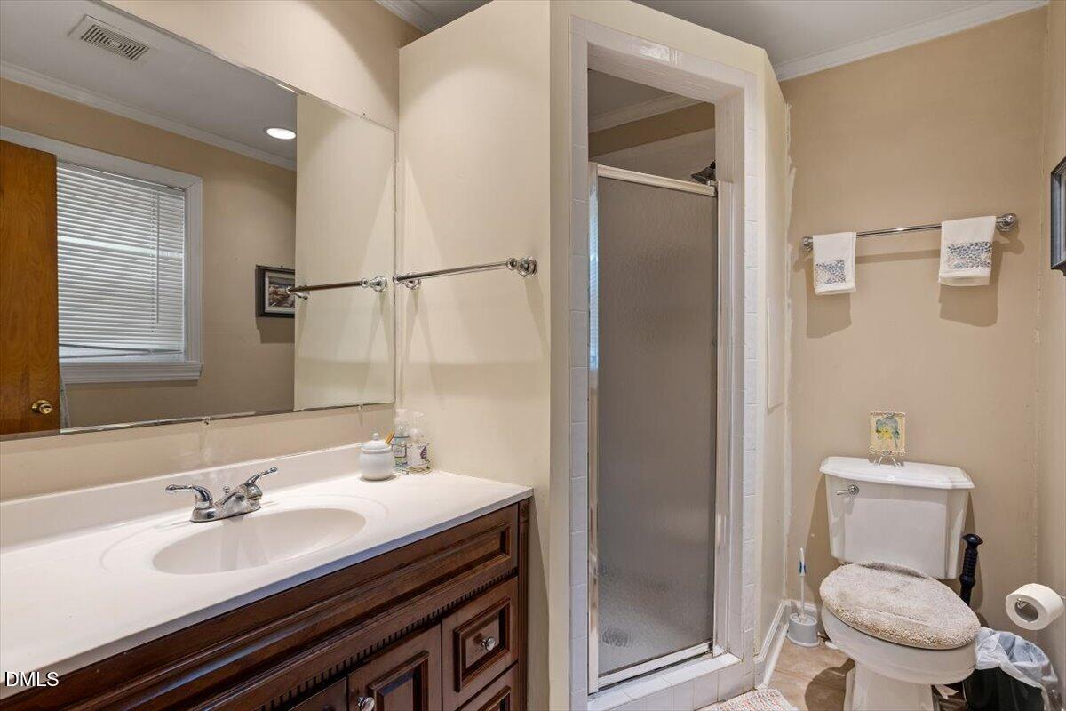 3107 Dixon Road Durham, NC 27707 - Photo 23 of 35 a bathroom with a sink toilet vanity and shower