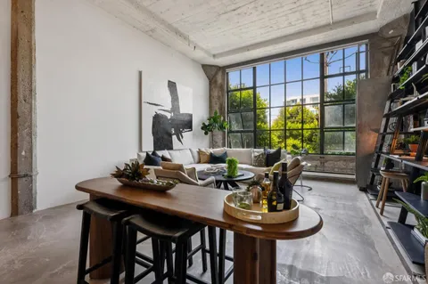 a view of a dining room with furniture and a potted plant