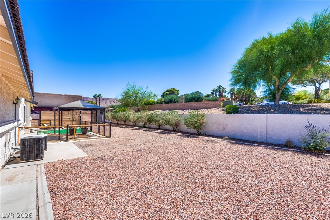 524 Swallow Cove Boulder City, NV 89005 - Photo 44 of 58 A spacious, rock-covered backyard provides a low-maintenance outdoor living area with a shaded patio.