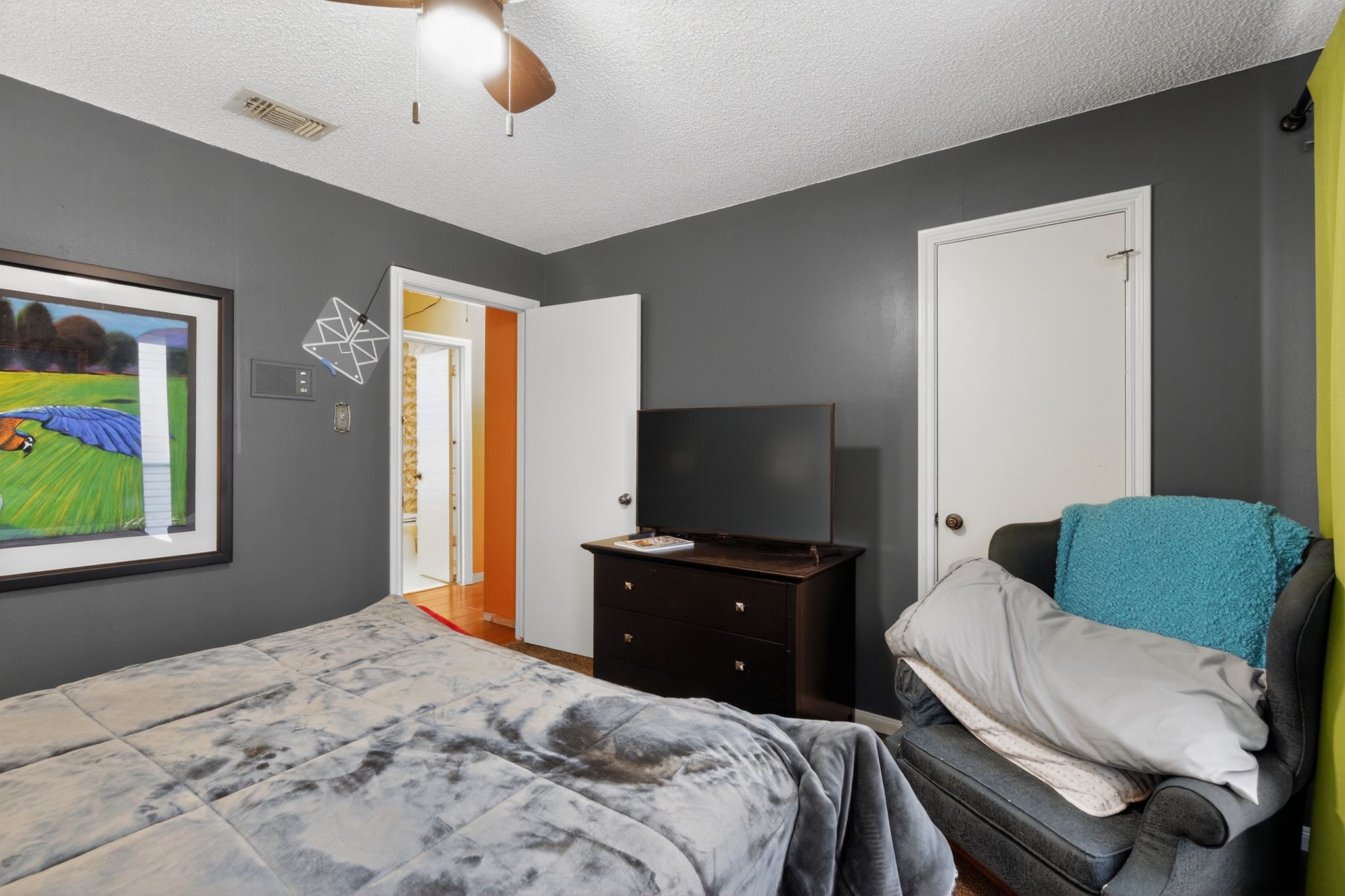 7815 Hummingbird Street Houston, TX 77071 - Photo 12 of 24 a bedroom with a bed and a flat screen tv