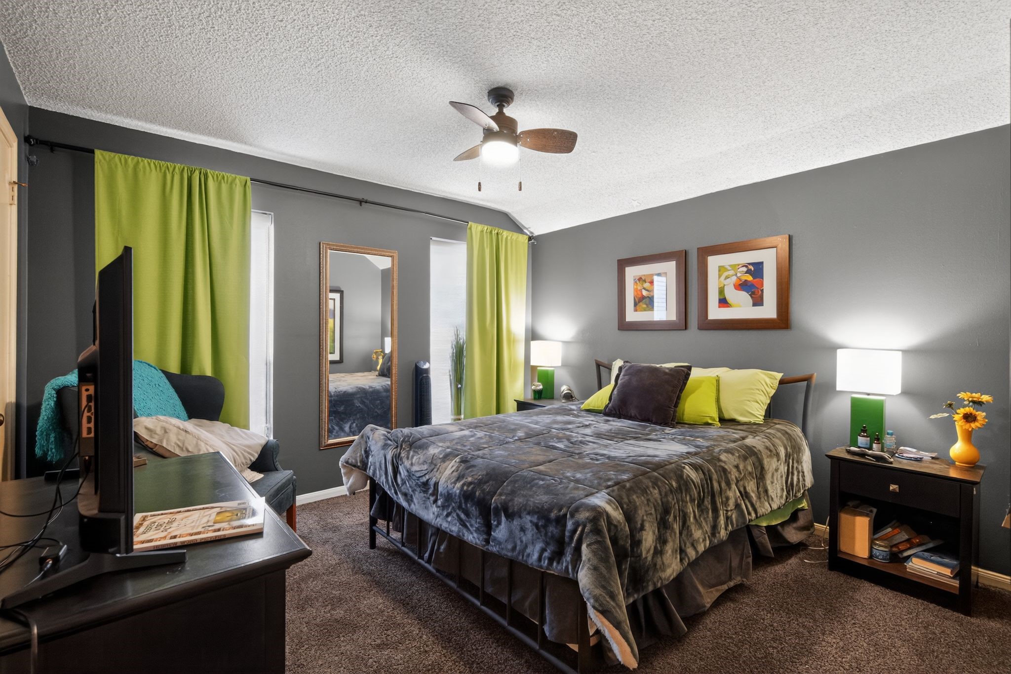 7815 Hummingbird Street Houston, TX 77071 - Photo 13 of 24 a bedroom with a bed and a chandelier