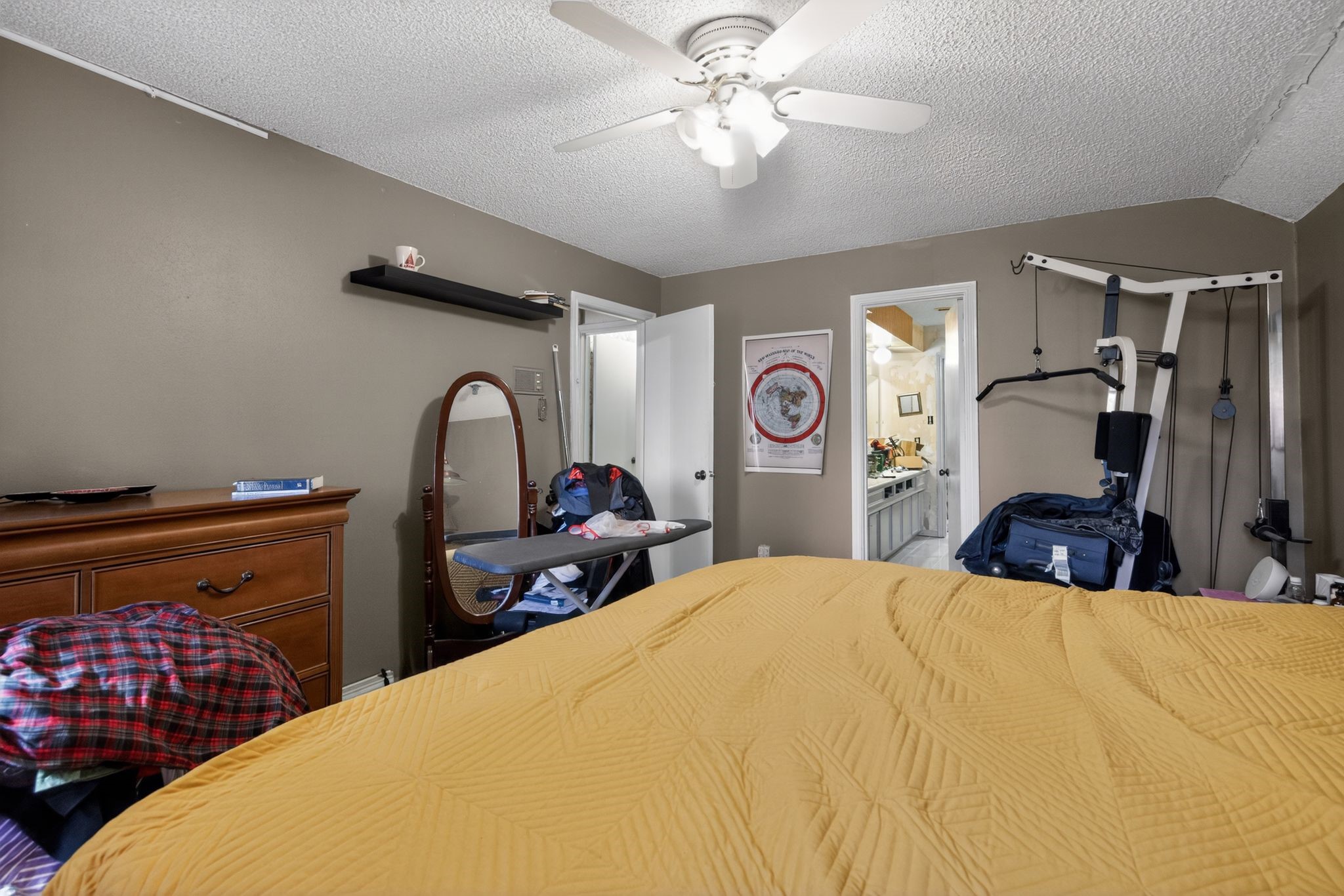 7815 Hummingbird Street Houston, TX 77071 - Photo 14 of 24 a bedroom with a bed and a chandelier