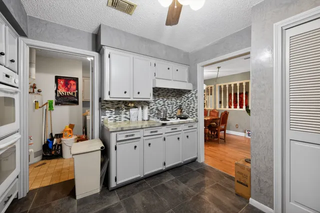 a room with gym equipment and wooden floor