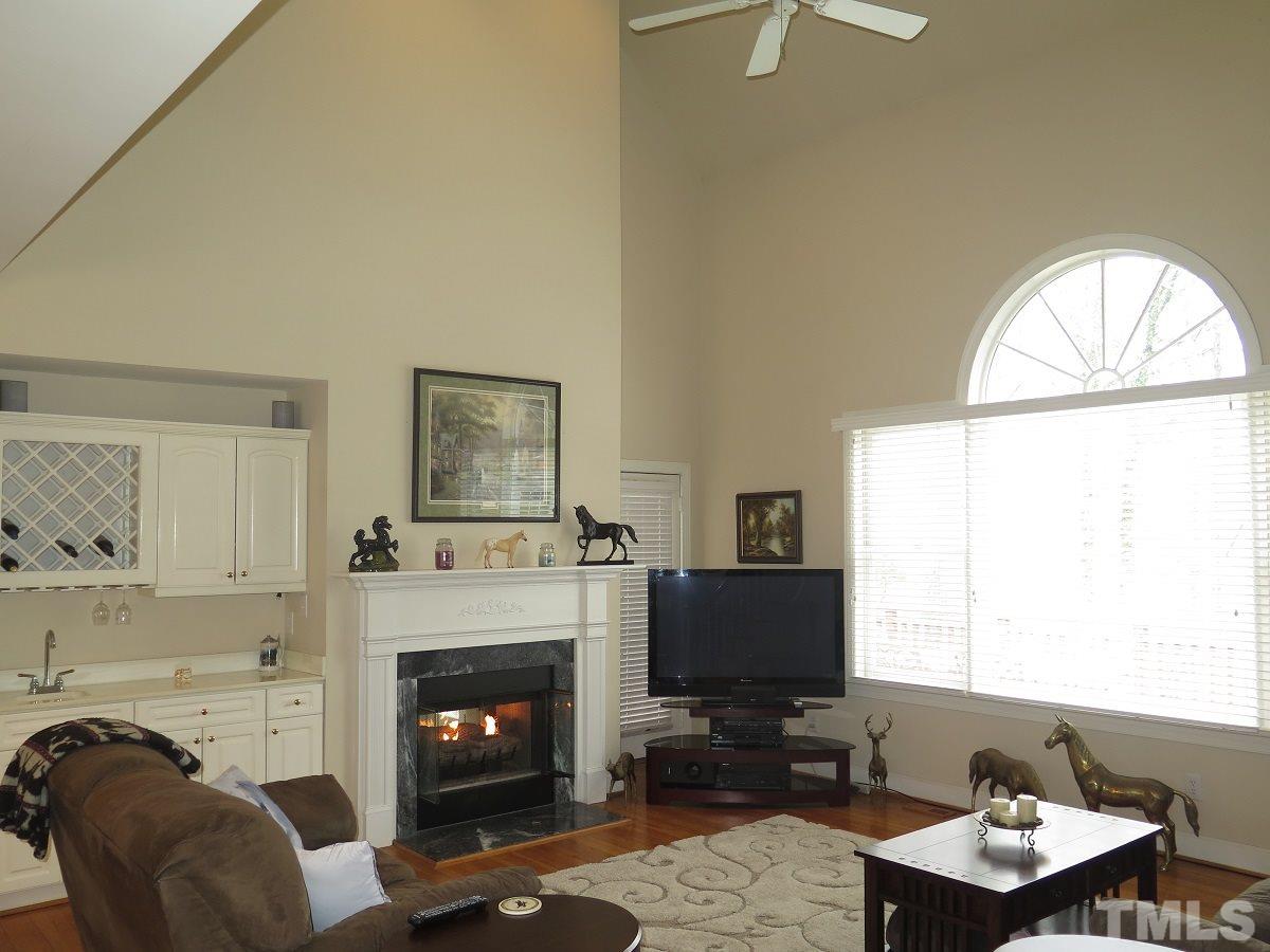11316 John Allen Road Raleigh, NC 27614 - Photo 2 of 25 a living room with furniture a fireplace and a flat screen tv