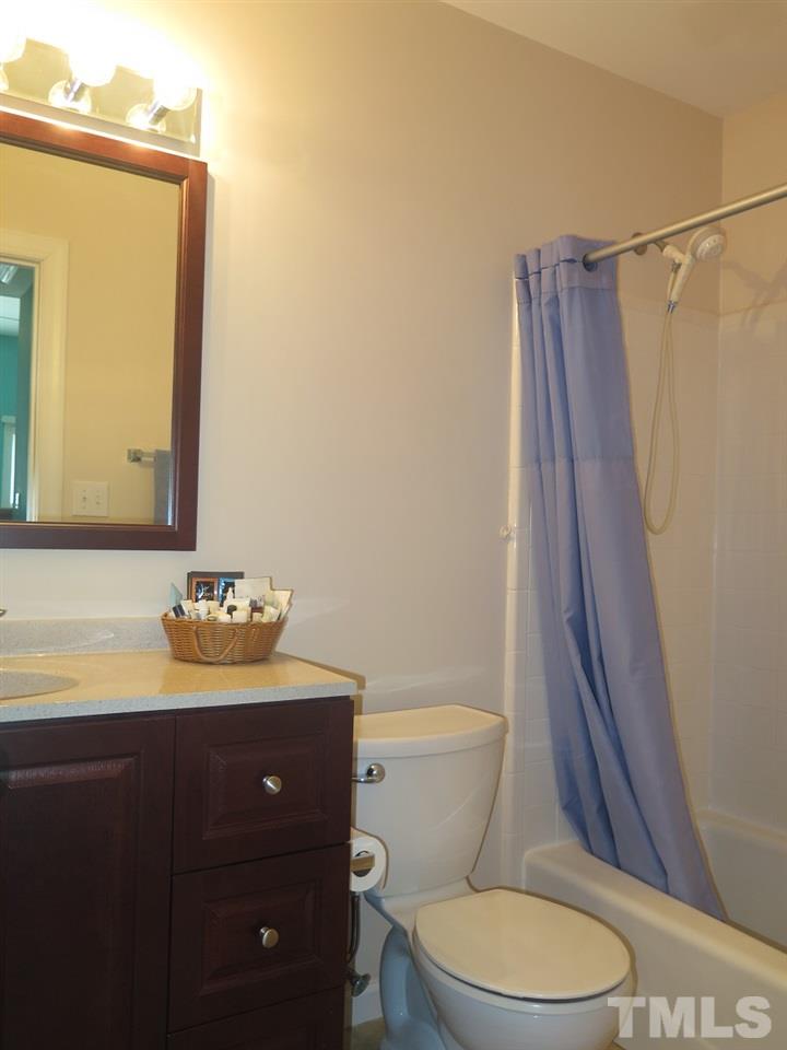 11316 John Allen Road Raleigh, NC 27614 - Photo 12 of 25 a bathroom with a sink a toilet a mirror and shower