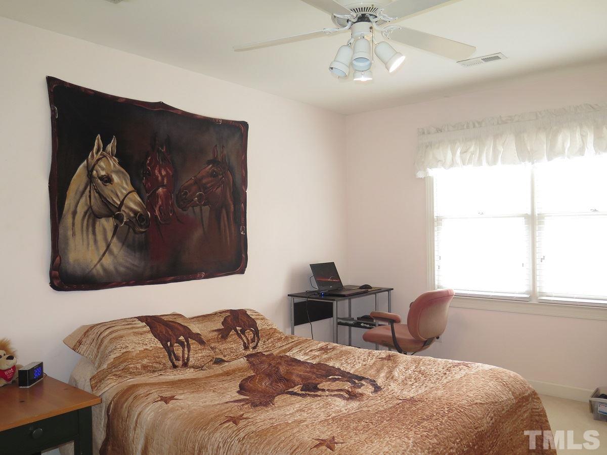 11316 John Allen Road Raleigh, NC 27614 - Photo 13 of 25 a bedroom with a bed and a window
