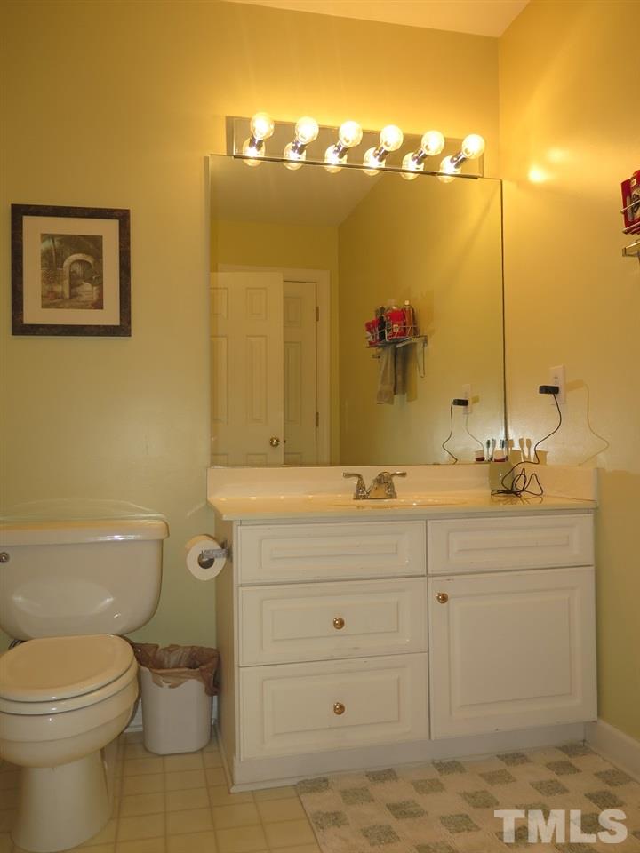 11316 John Allen Road Raleigh, NC 27614 - Photo 14 of 25 a bathroom with a granite countertop toilet sink and mirror