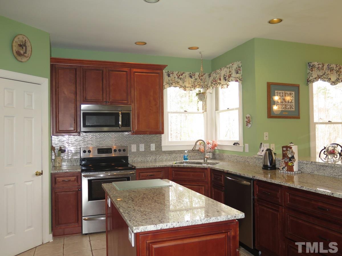 11316 John Allen Road Raleigh, NC 27614 - Photo 6 of 25 a kitchen with stainless steel appliances granite countertop a sink stove and microwave