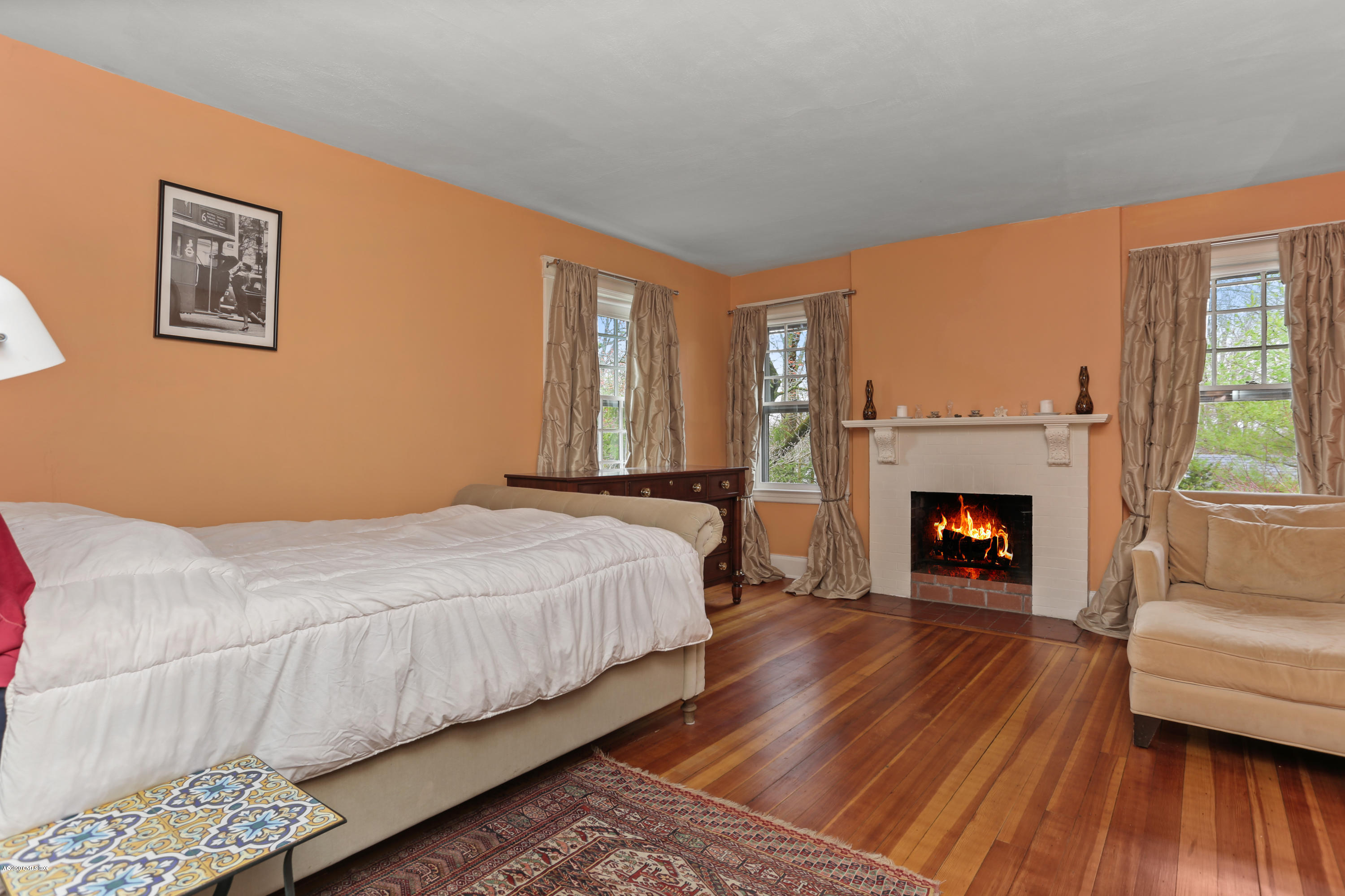18 Leonard Avenue Riverside, CT 06878 - Photo 17 of 28 a bedroom with a bed and a fireplace
