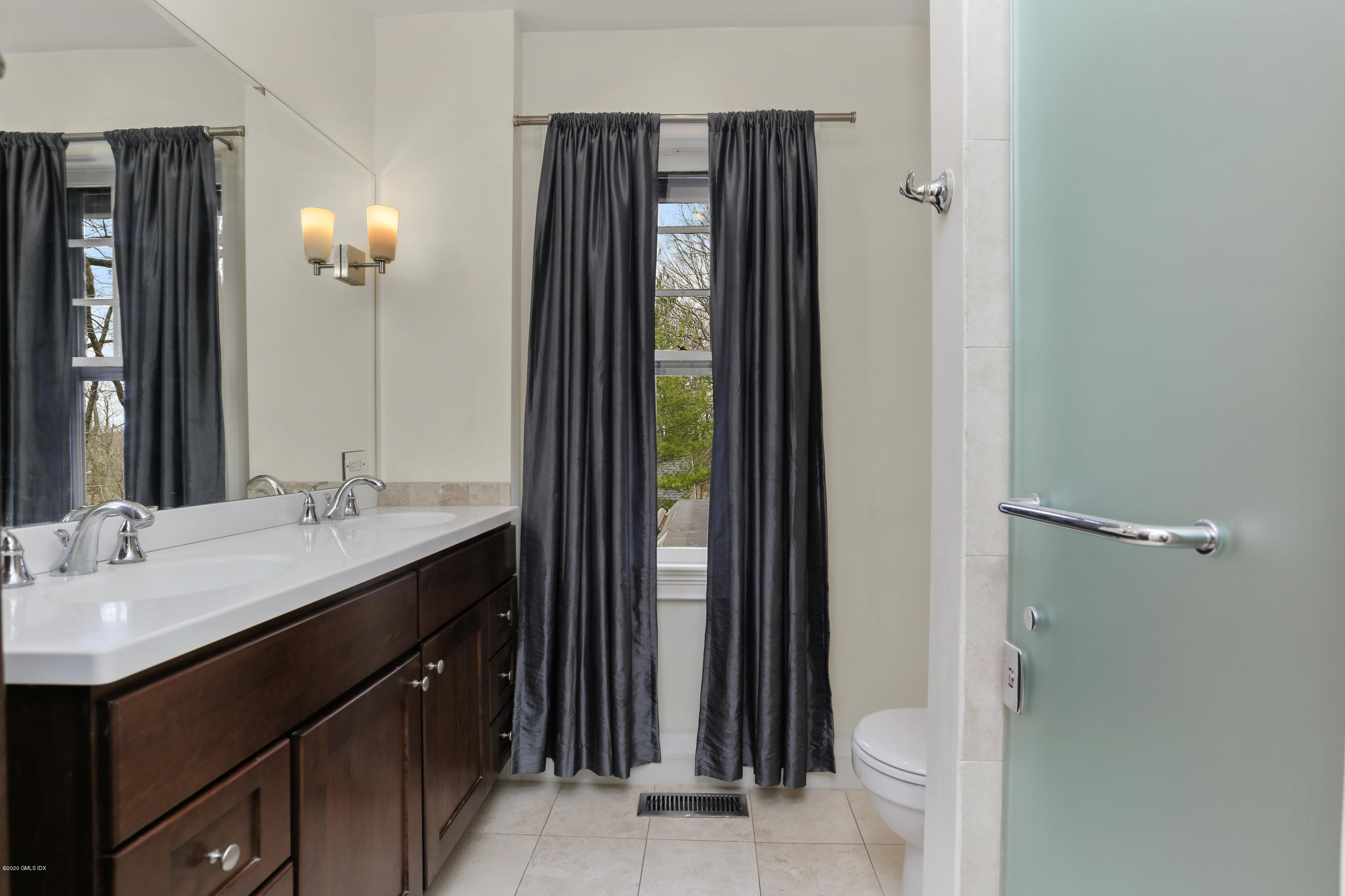 18 Leonard Avenue Riverside, CT 06878 - Photo 22 of 28 a bathroom with a sink a mirror and a shower