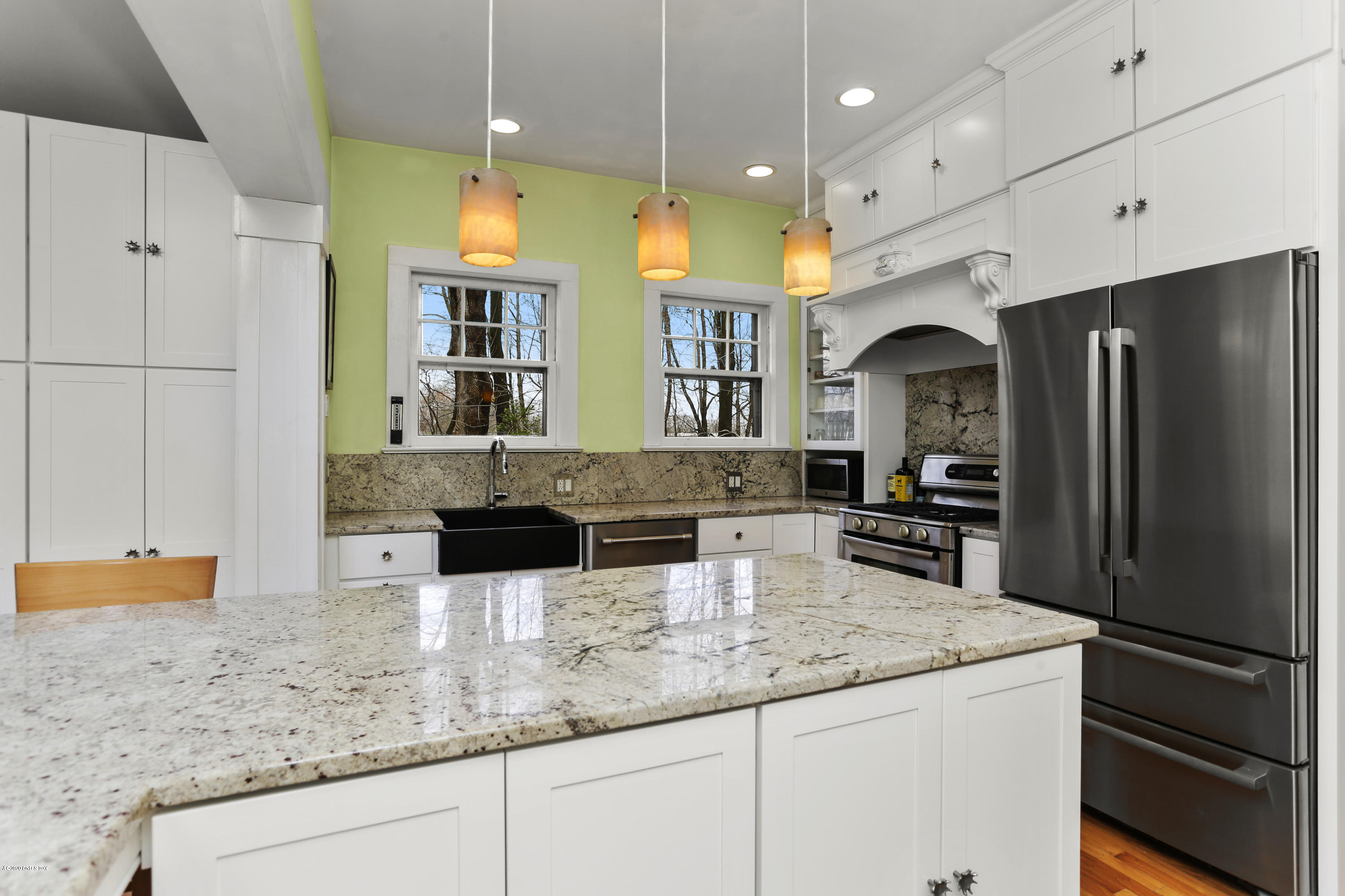 18 Leonard Avenue Riverside, CT 06878 - Photo 8 of 28 a kitchen with stainless steel appliances granite countertop a sink a refrigerator and a granite counter tops