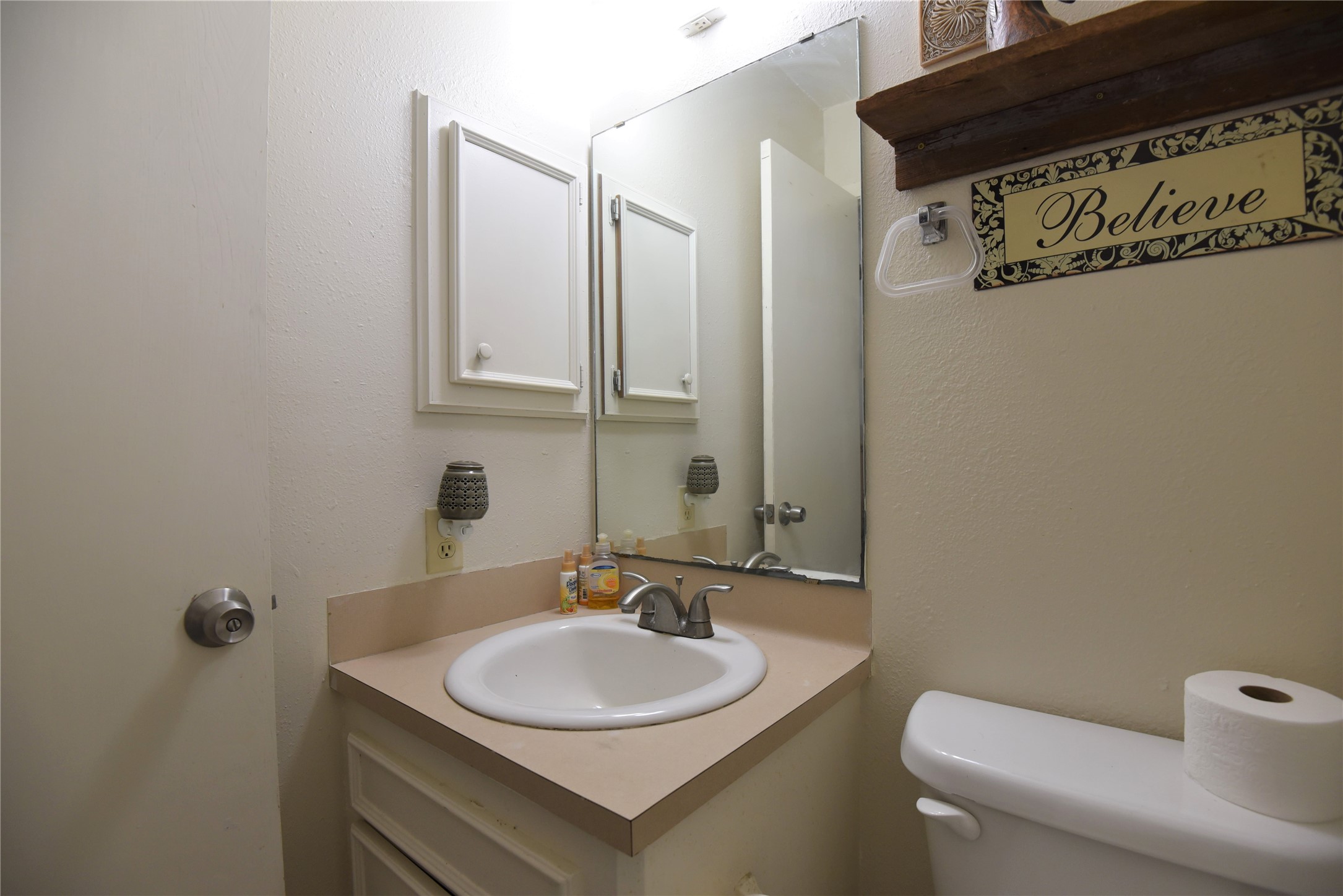 2231 US 90 Schulenburg, TX 78956 - Photo 14 of 31 a bathroom with a sink a toilet and a mirror