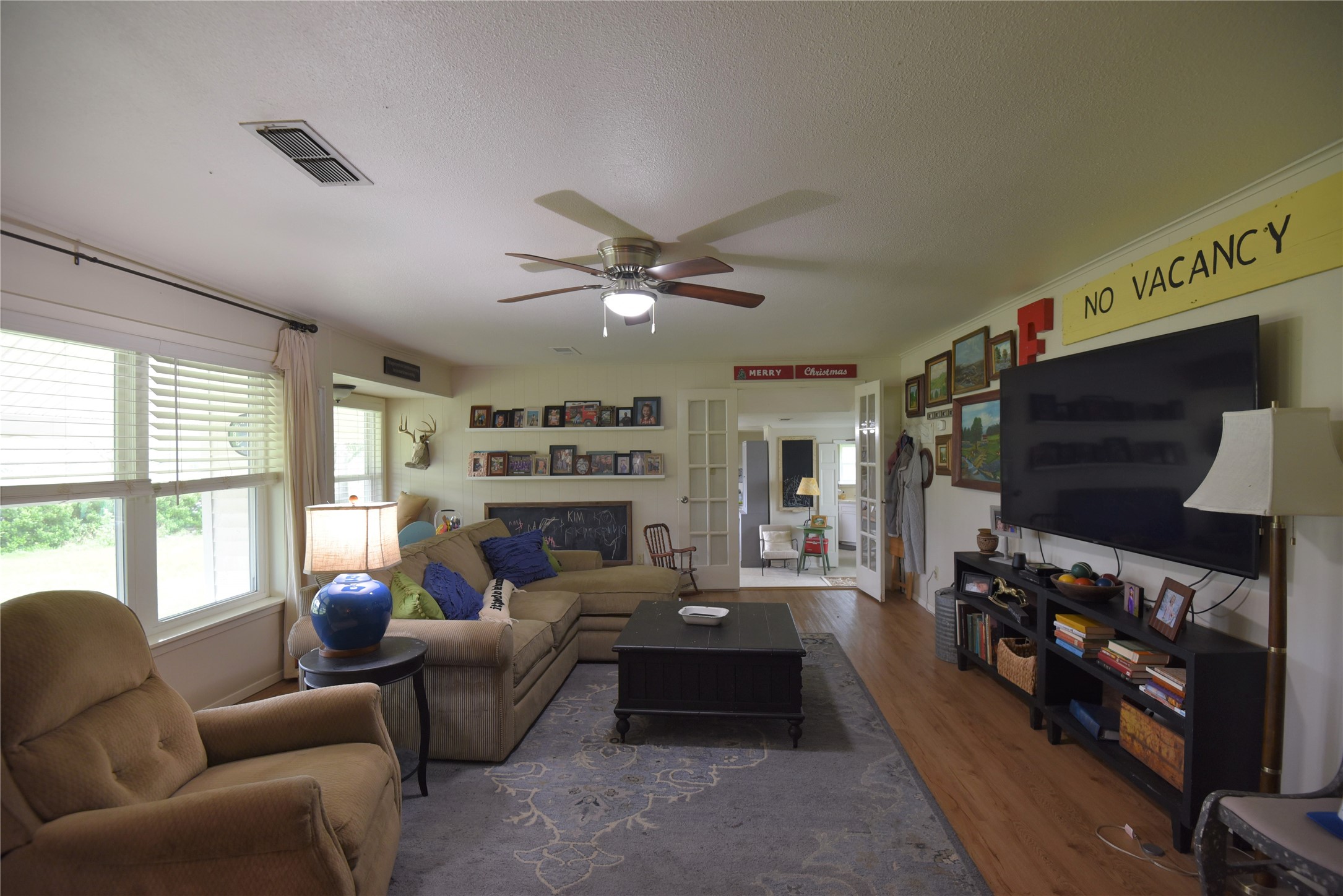 2231 US 90 Schulenburg, TX 78956 - Photo 9 of 31 a living room with furniture a flat screen tv and a fireplace