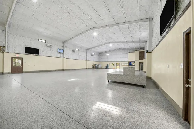a view of a hallway with a couch and chandelier