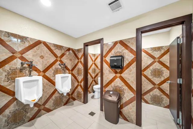 a view of a hallway with wooden floor and a flat screen tv