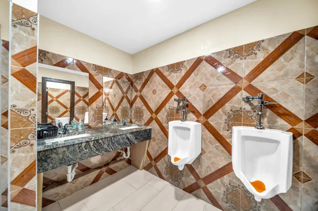 a bathroom with double vanity sinks and a mirror