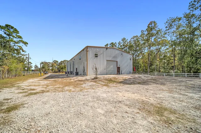 a view of a yard with wooden fence