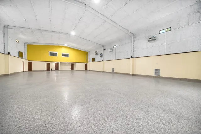a view of a livingroom with furniture and a window