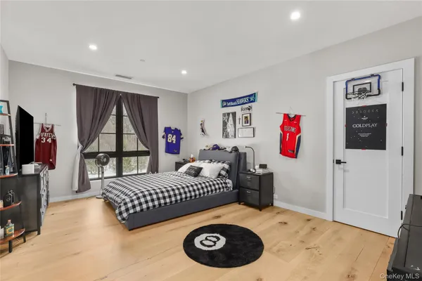 a bedroom with a bed and a large window