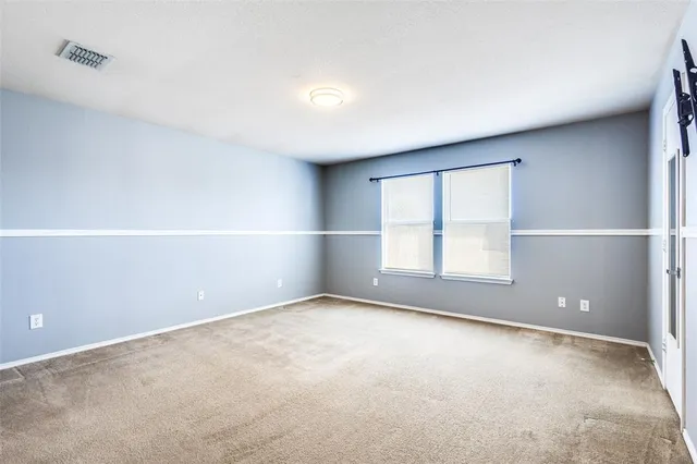 an empty room with a empty space and windows