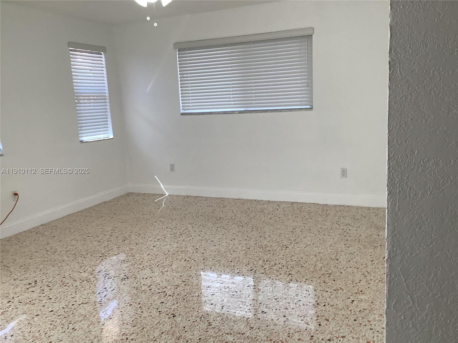 7435 Southwest 23rd Street, Unit FRONT Miami, FL 33155 - Photo 15 of 28 an empty room with a window