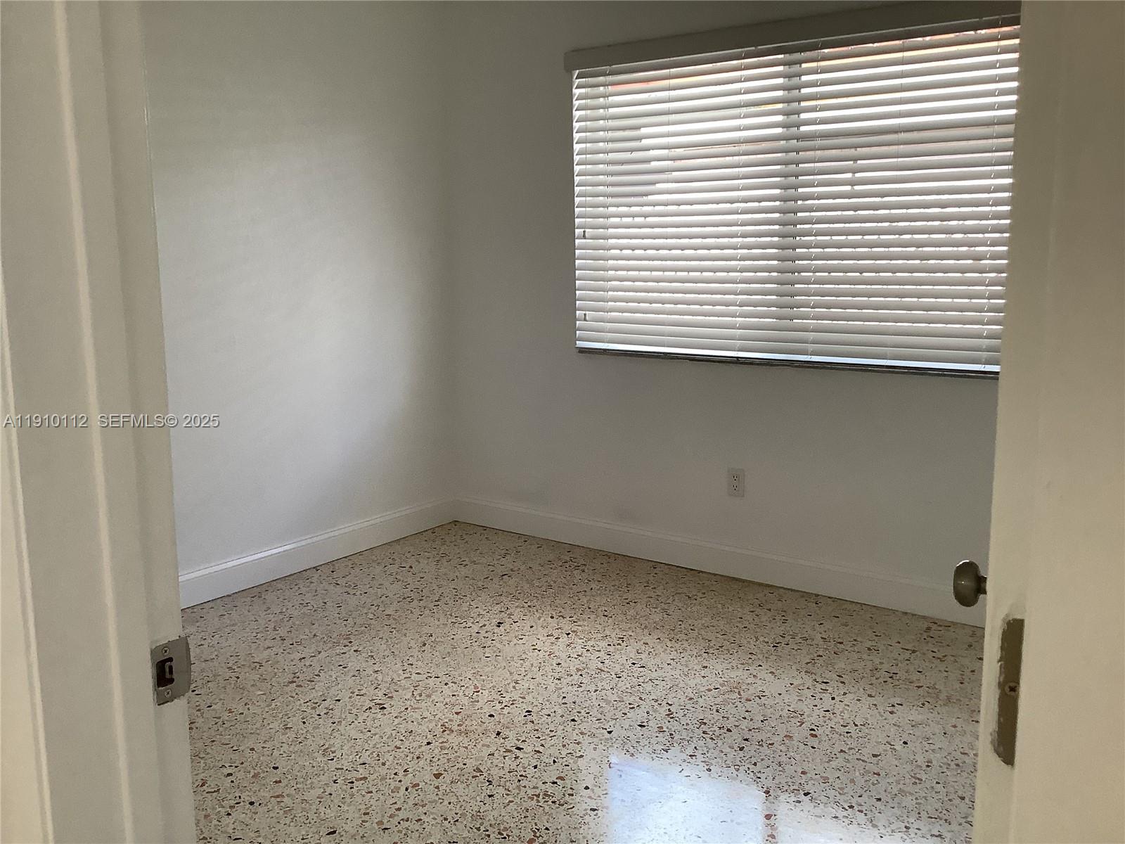 7435 Southwest 23rd Street, Unit FRONT Miami, FL 33155 - Photo 24 of 28 an empty room with a window