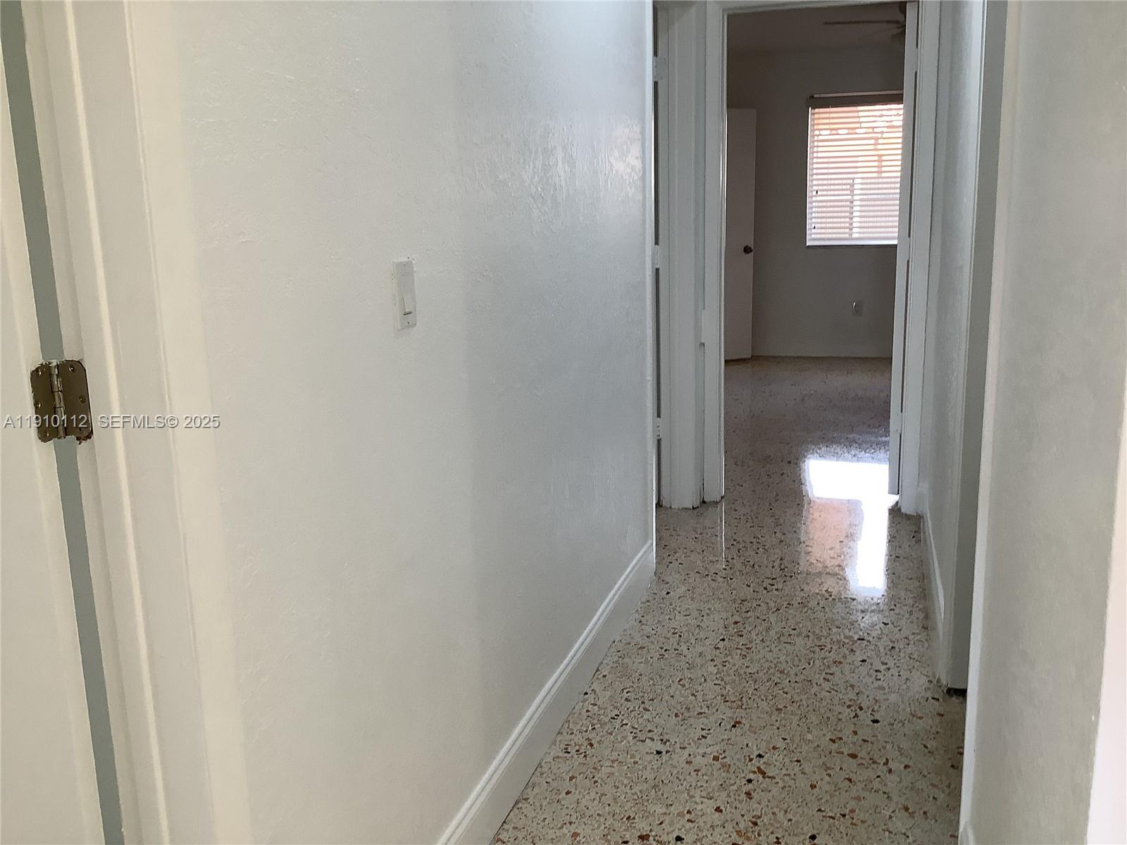 7435 Southwest 23rd Street, Unit FRONT Miami, FL 33155 - Photo 25 of 28 a bathroom with a light fixture and a mirror