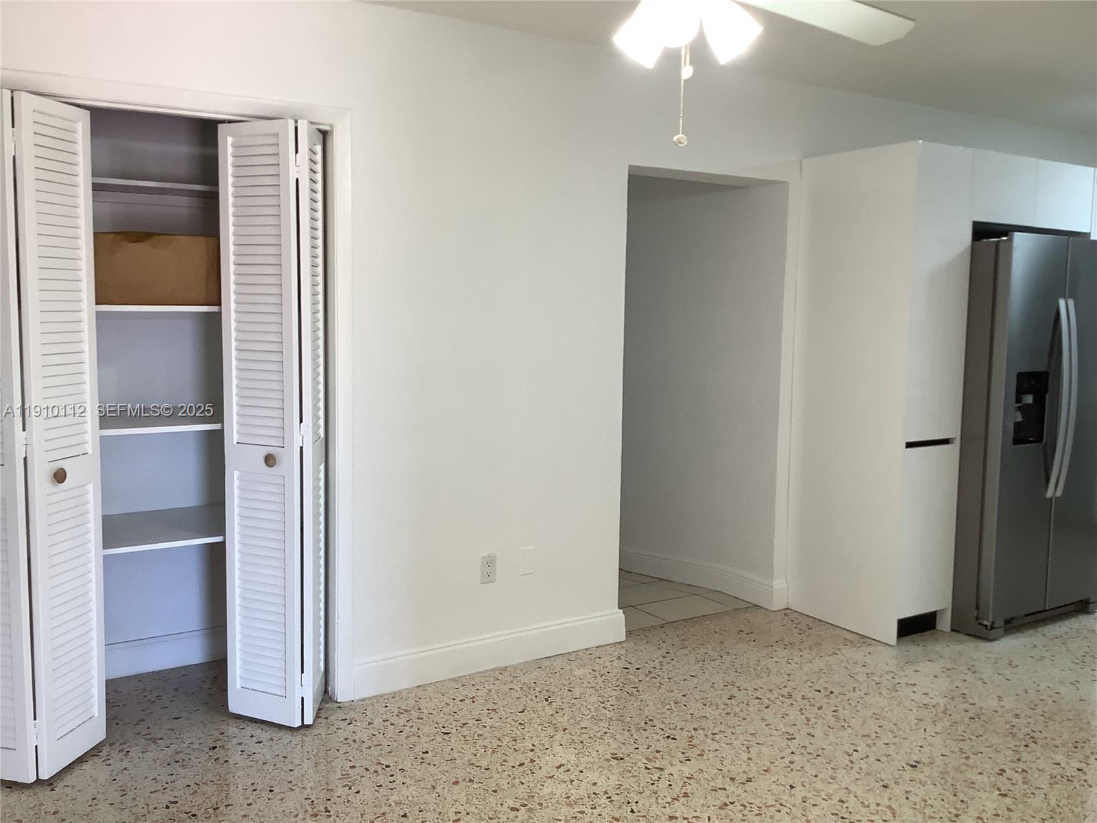 7435 Southwest 23rd Street, Unit FRONT Miami, FL 33155 - Photo 4 of 28 a view of an empty room with a fireplace