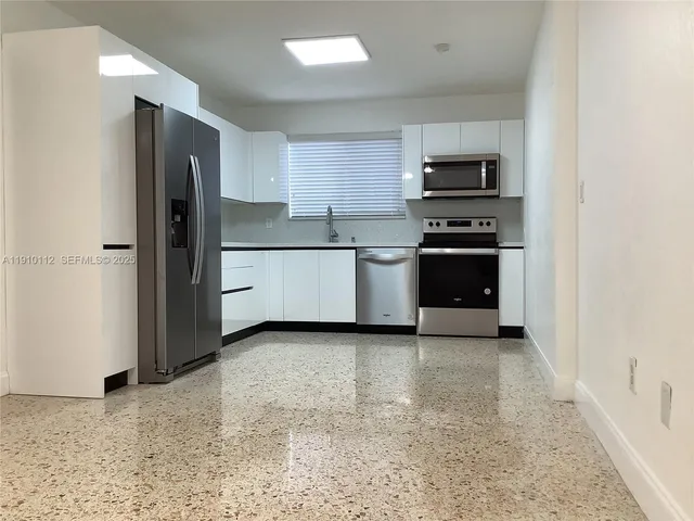 a kitchen with stainless steel appliances a refrigerator stove microwave and sink