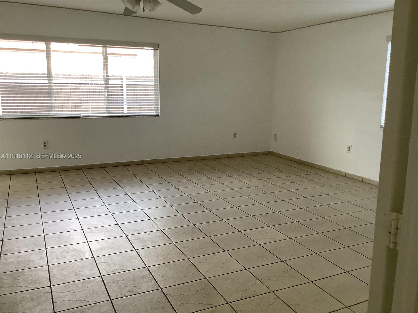 7435 Southwest 23rd Street, Unit FRONT Miami, FL 33155 - Photo 8 of 28 an empty room with a window