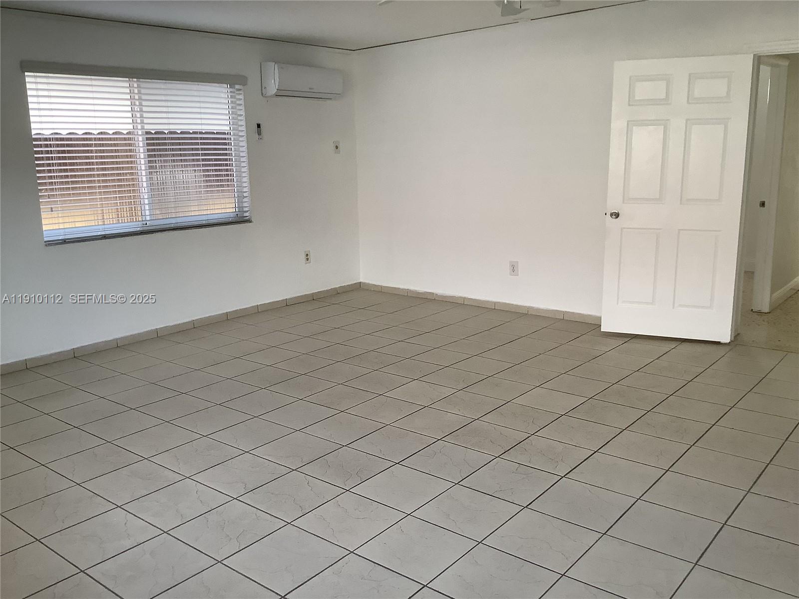 7435 Southwest 23rd Street, Unit FRONT Miami, FL 33155 - Photo 9 of 28 an empty room with windows