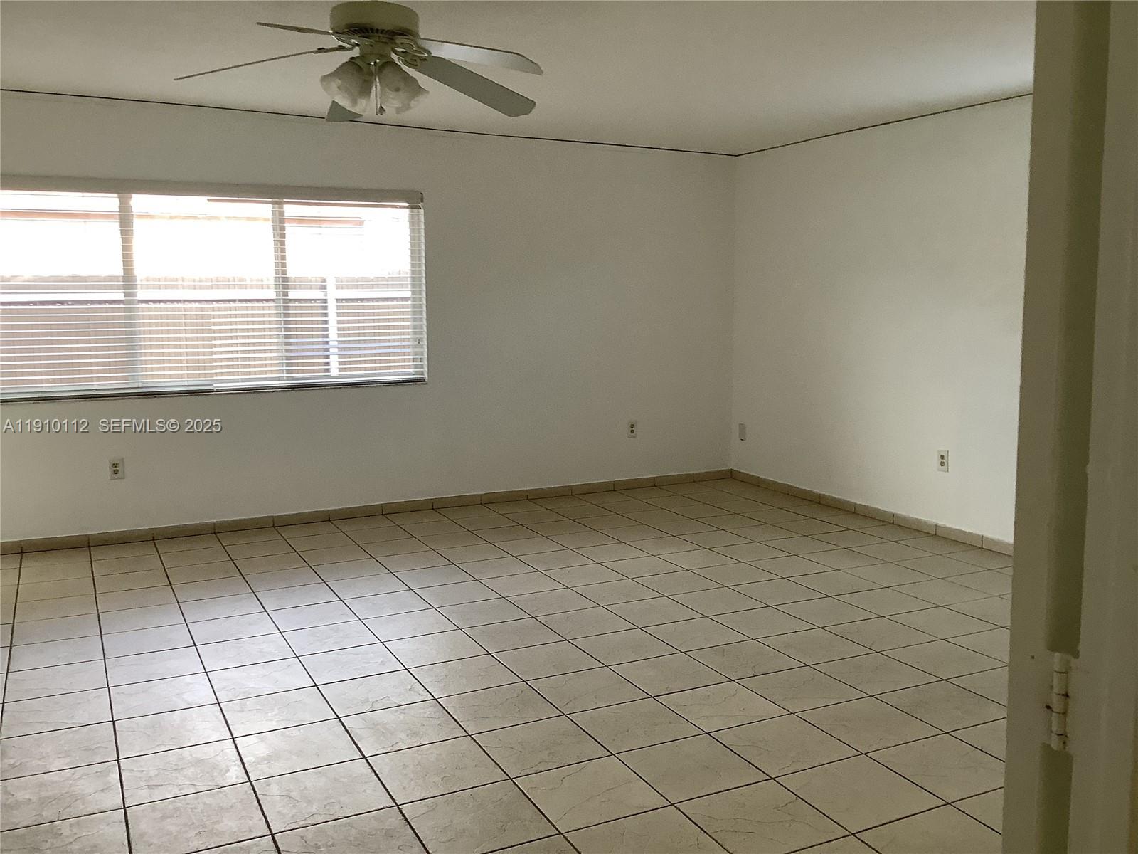7435 Southwest 23rd Street, Unit FRONT Miami, FL 33155 - Photo 10 of 28 an empty room with windows